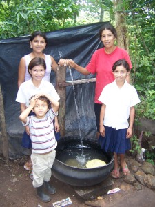This family uses an inside-out tire to collect water for bathing and washing clothes.
